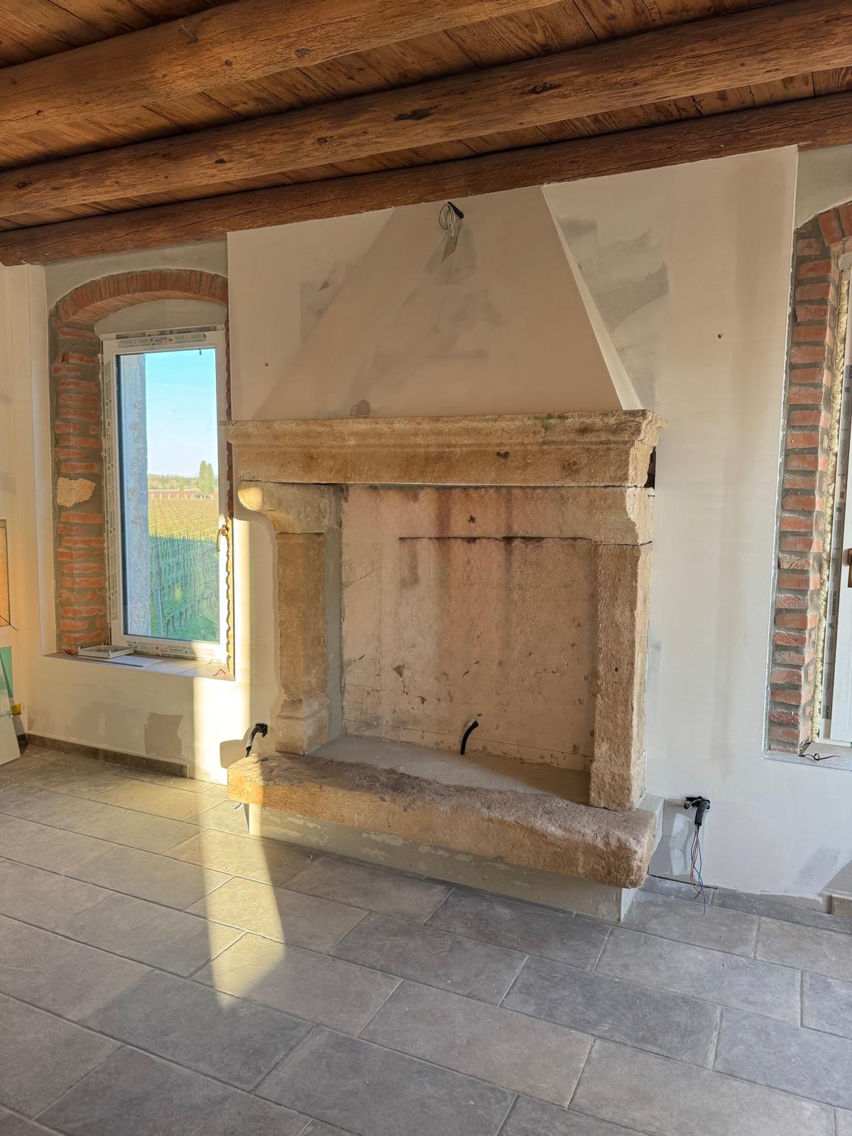 Camino in pietra con cappa in cartongesso: intervento estetico e di design | Fontana Cartongesso